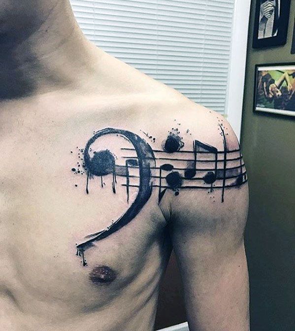 Shoulder watercolor notes with music staff tattoo designs for guys