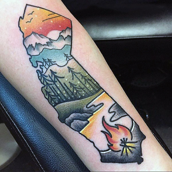 Simple forest scene with fire and lake tattoo on forearm on male