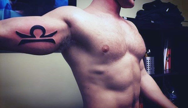 Solid black ink guys libra sign inner arm bicep tattoo