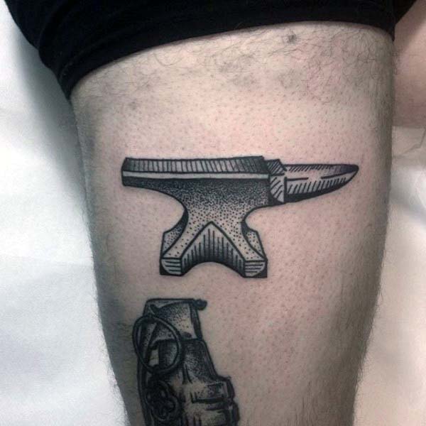 Thigh anvil woodcut tattoo for men