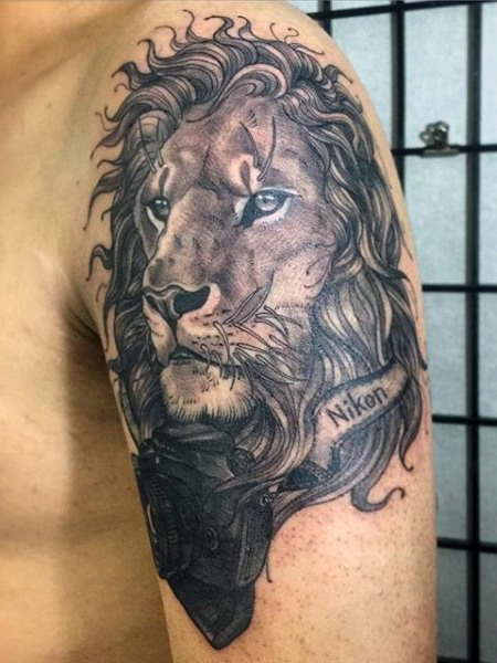 Upper arm lion tattoo designs for men