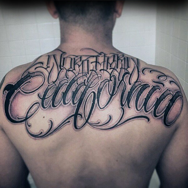 Upper back cool script tattoo