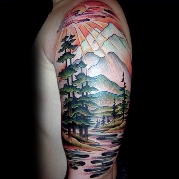 Watercolor scene of sun rays through forest upper sleeve tattoo on man