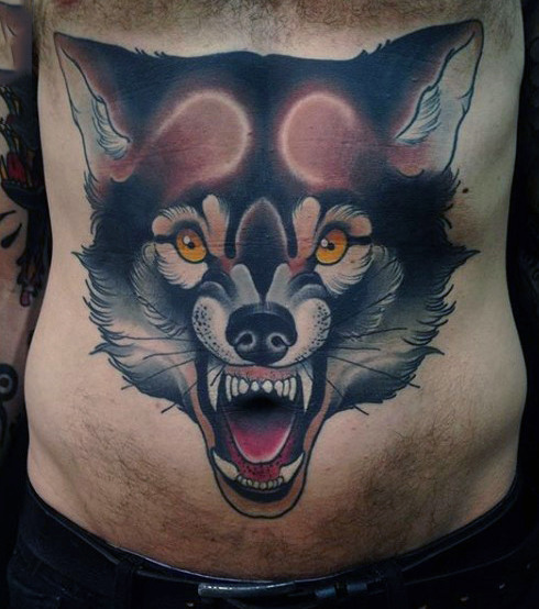 Big wolf face tattoo on mans stomach