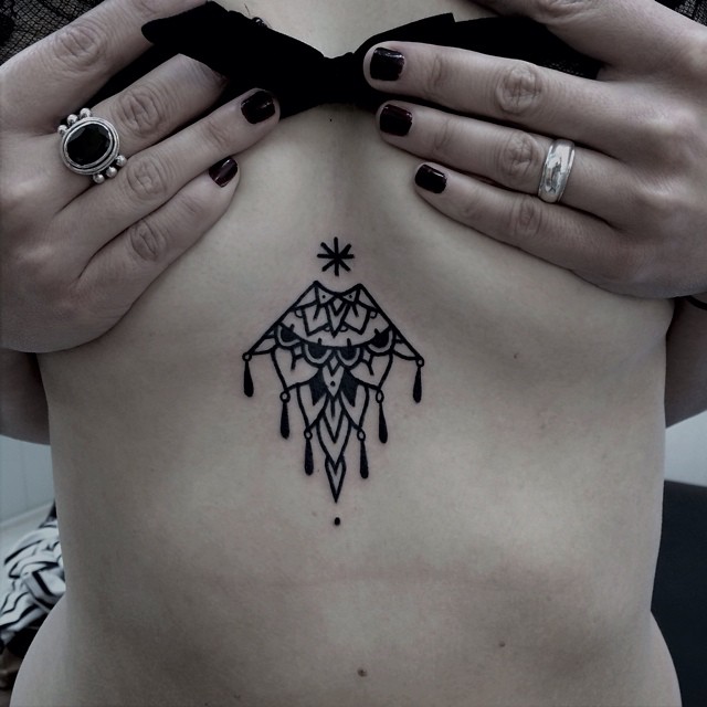 Black Ornament Tattoo On The Sternum Black Ornament Tattoo On The Sternum