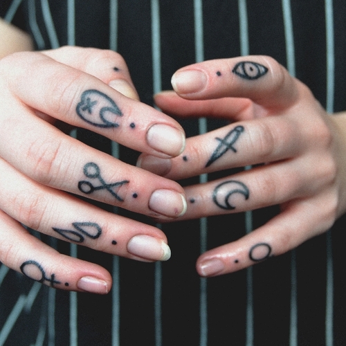 Black Symbol Tattoos On Fingers
