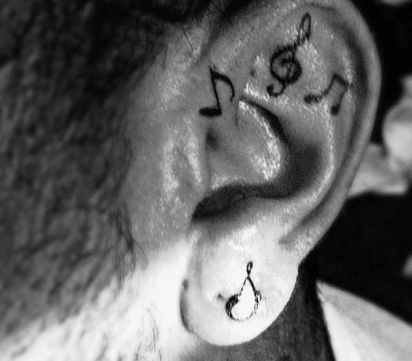 Cool male music note ear tattoo