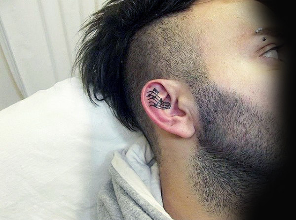 Cool music notes male ear tattoo