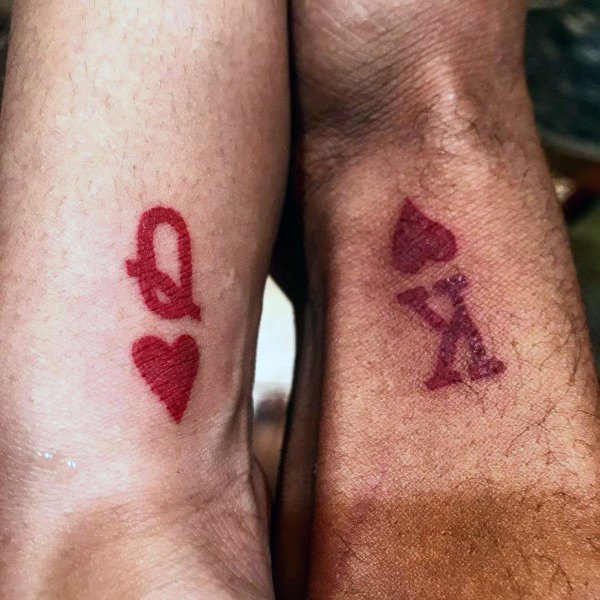 Cute couple tattoos king and queen design with red ink and hearts