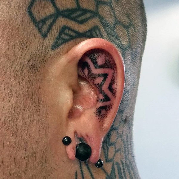 Ear tattoo of dotwork star