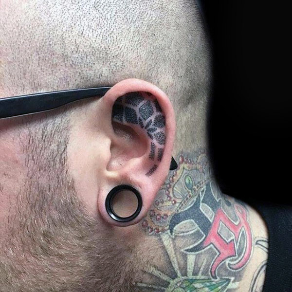 Floral dotwork inner ear tattoo