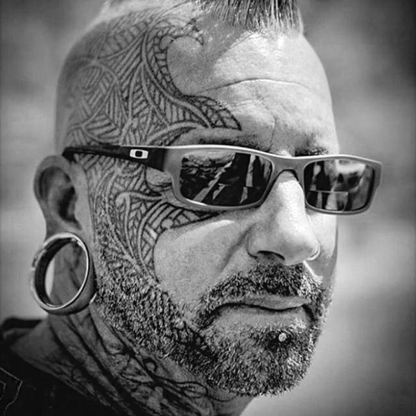 Gentleman with tribal face tattoo design