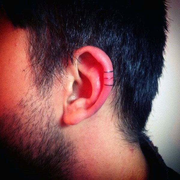 Linework black and red ink lines male ear tattoo