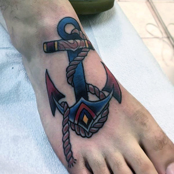 Man with navy blue anchor tattoo on foot