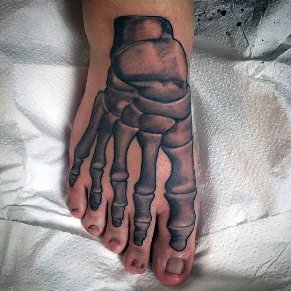Man with skeletal bones tattoo on foot