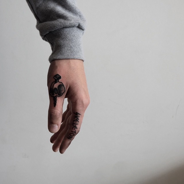 Nail Stabbed Skull Tattoo