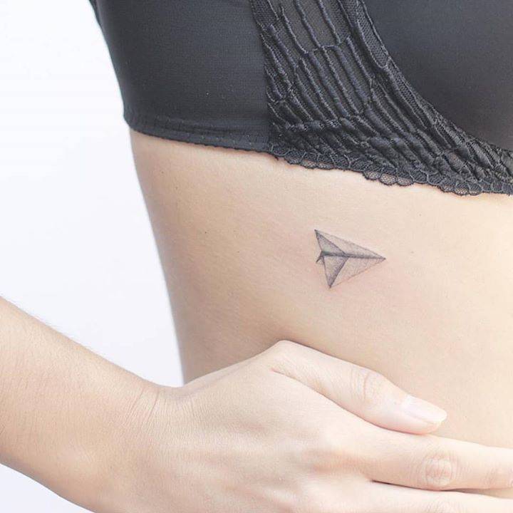 Paper Plane Rib Tattoo