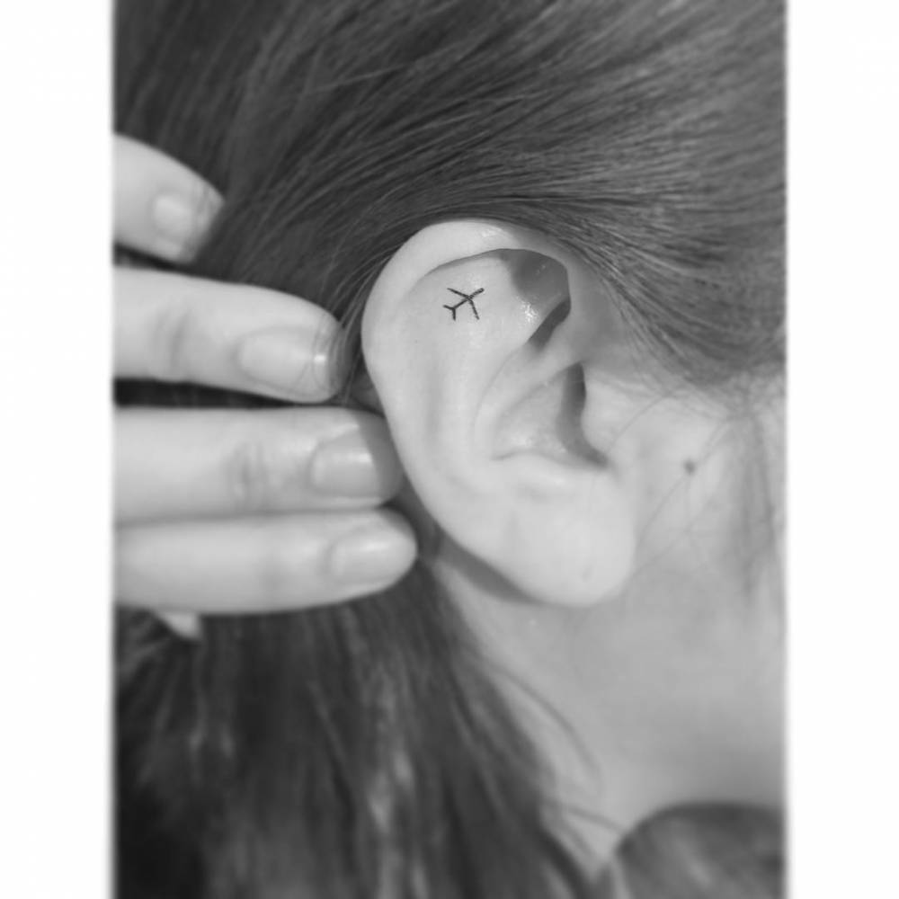 Small Airplane Tattoo On The Ear