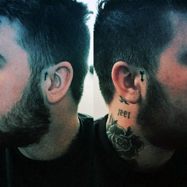 Small arrow and cross ear tattoo for guys