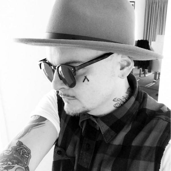 Small mens straight razor face tattoo
