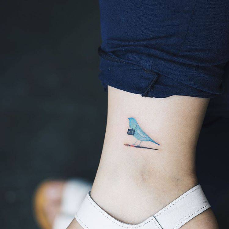 Tiny Tattoo Of A Bluebird On An Ankle