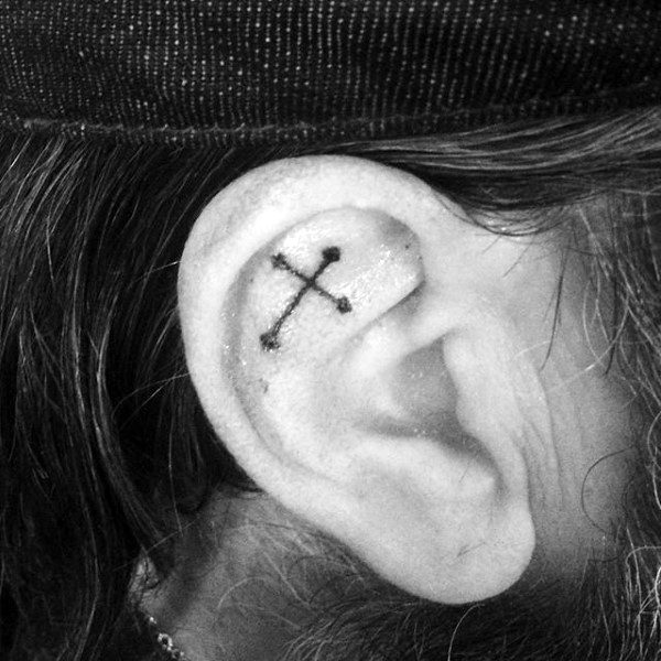 Tiny mens cross ear tattoo