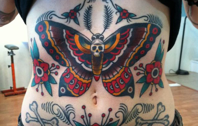 Colorful butterfly Tattoo with skulls on abs