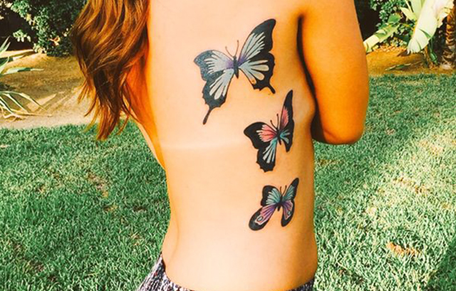 Gilr's side butterfly tattoo
