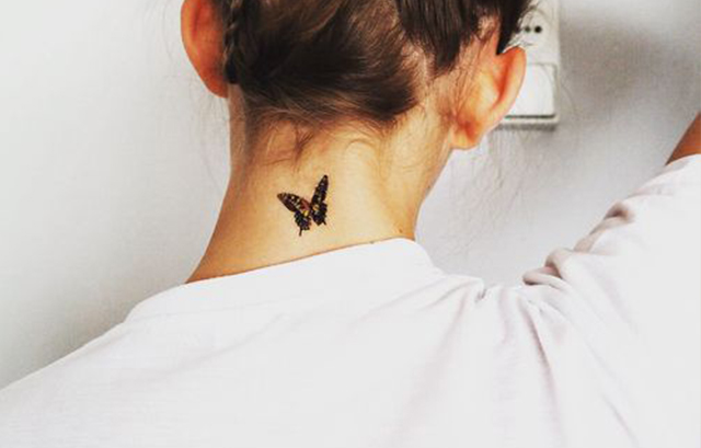 small butterfly nape tattoo