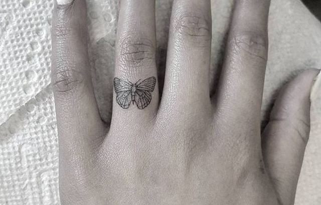 Tiny Butterfly tattoo on finger