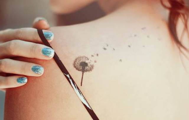 Tiny Dandelion Flower Tattoo on Her Shoulder