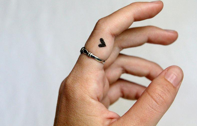 Tiny Heart Tattoo on Her Finger