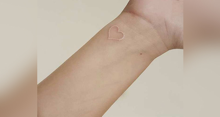 Tiny Heart Tattoo on her Side of Wrist