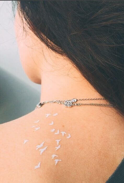 tiny white bird tattoo designs on back