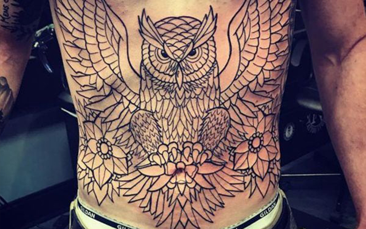 Owl tattoo on stomach