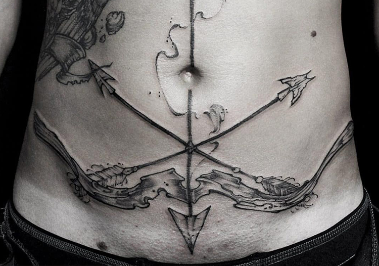 Arrow tattoo on stomach