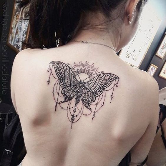 Mandala butterfly tattoo on spine