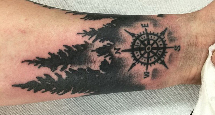 Pine tree with compass tattoo