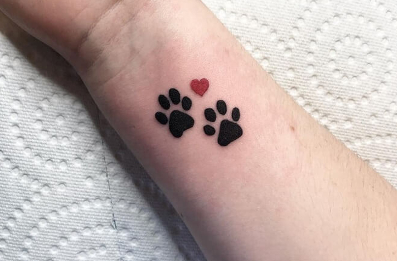 Paw prints tattoo on wrist