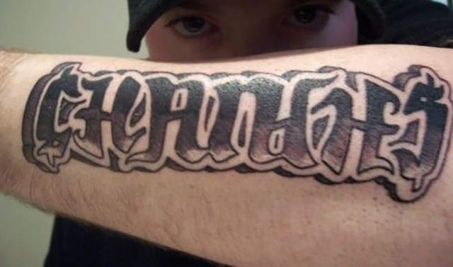 ‘Changes’ in graffiti font on forearm ambigram tattoo