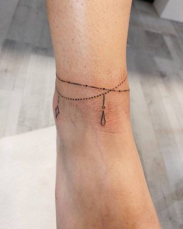 Miniature anklet tattoo on ankle