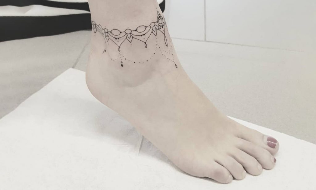 Anklet tattoo on girl ankle