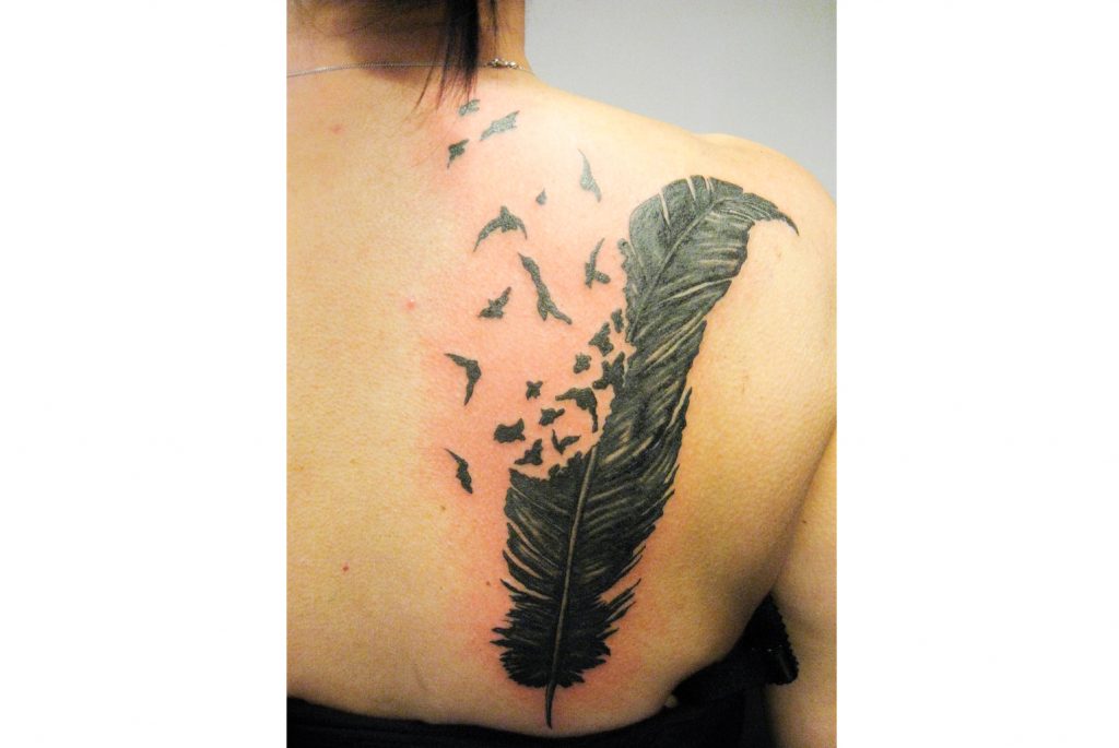 Crow feather on your back tattoo