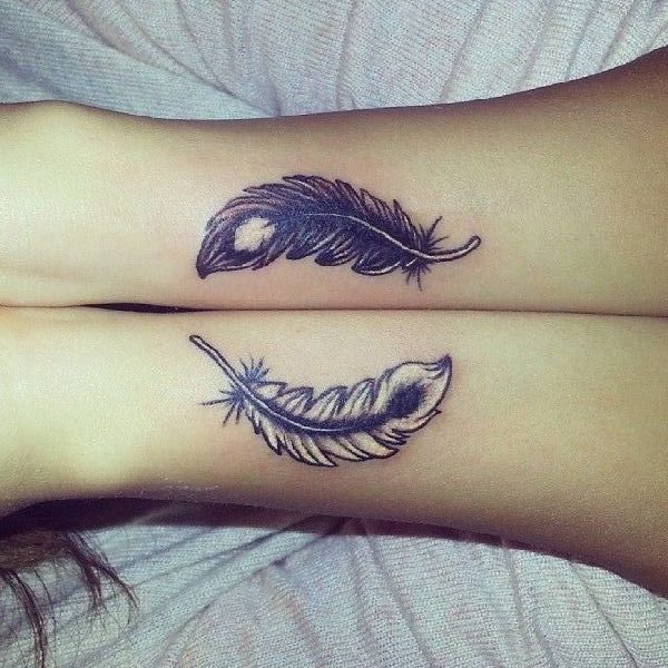 feather tattoo on both arms