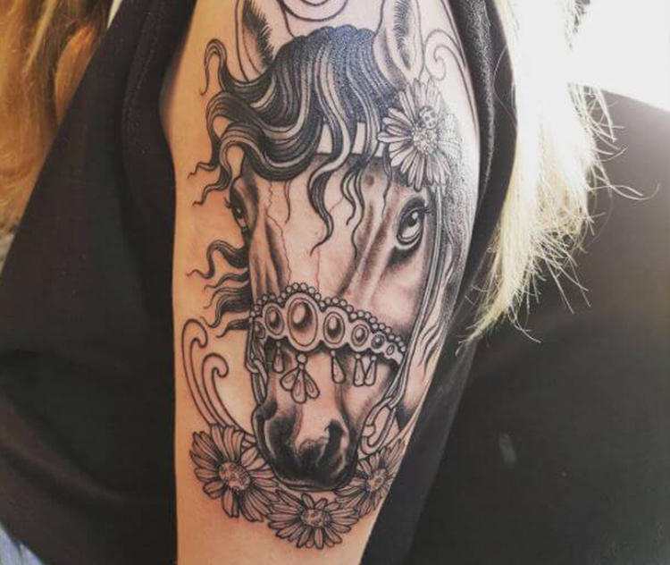 Horse head tattoo on arm