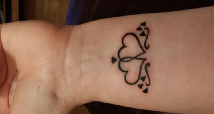 Intertwined heart tattoo