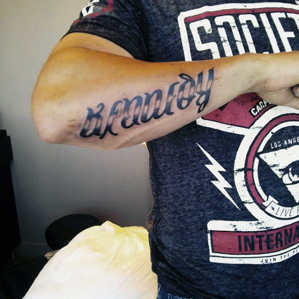 Name ambigram tattoo for men on outer forearm