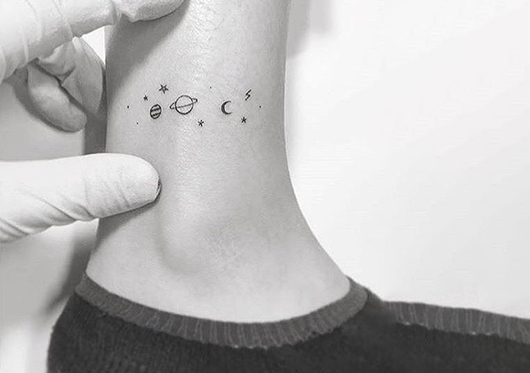 Planet tattoo on girl ankel