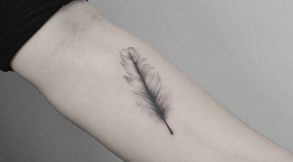 black white feather on your inner forearm Tattoo