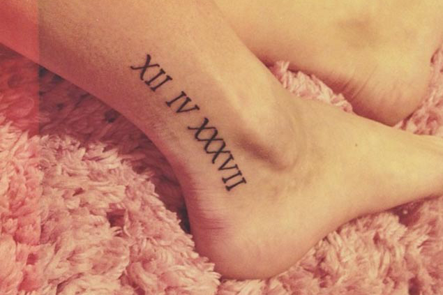 date in roman tattoo on girl ankle